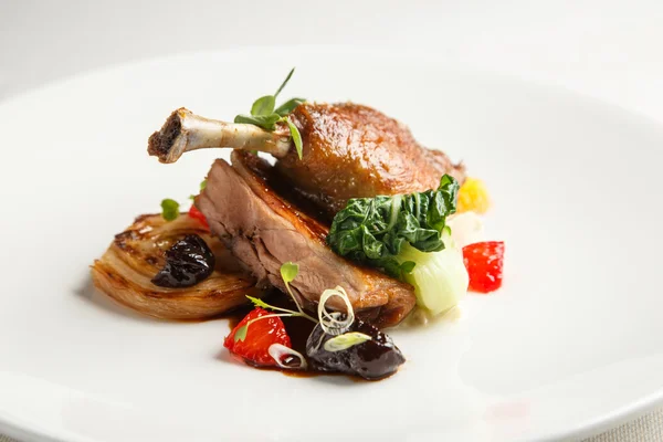 Well-browned and crisp duck confit with roast fennel, citrus fruit  prune sauce. Roasted  leg. White dish