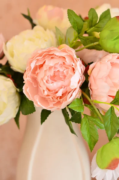 Pink and white flowers - peonies in a white porcelain vase.