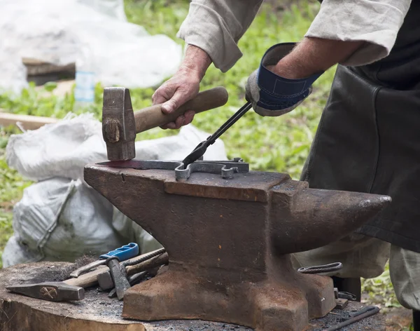 Blacksmith forges iron
