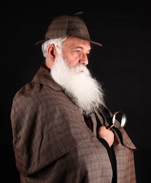 Bearded detective with magnifying glass