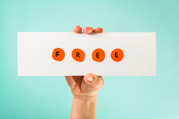 Hand holding a banner with the word Free.