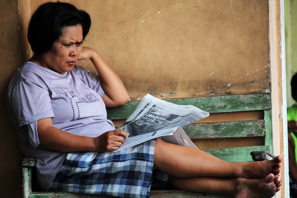 Lady reading newspaper