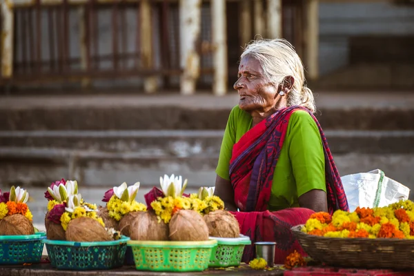 Old indian woman selling holy flowers near the Shri Chamundeshwari temple