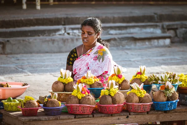 Old indian woman selling holy flowers near the Shri Chamundeshwari temple