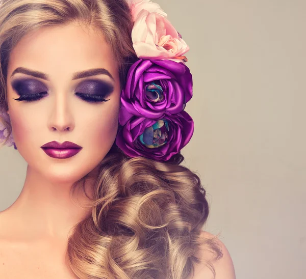 Woman with curly hair and flowers