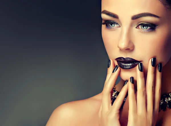 Woman  with black lips and manicure