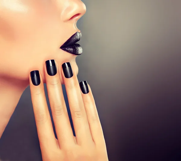 Beautiful girl with black manicure nails