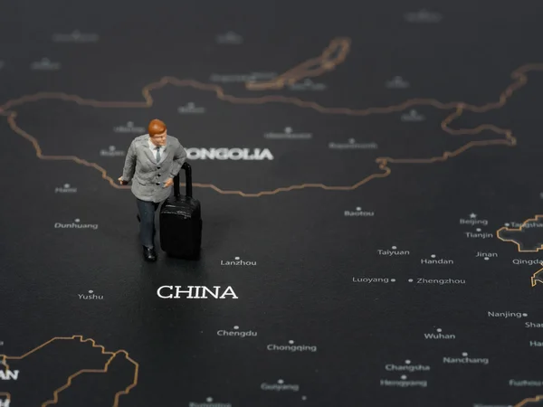 Miniature business man on map of China, Business Travel Concept.