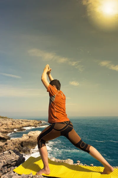 Young man practicing yoga and meditation in the sun.