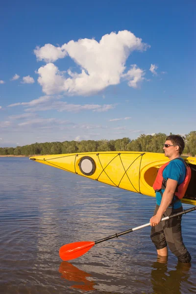 Men travel by canoe on the river in the summer a sunny day.