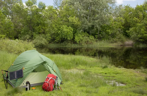 Camping in the woods on the banks of the river.