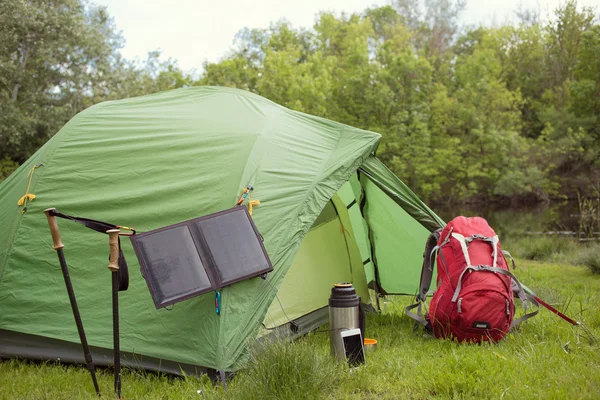 Camping in the woods on the banks of the river.