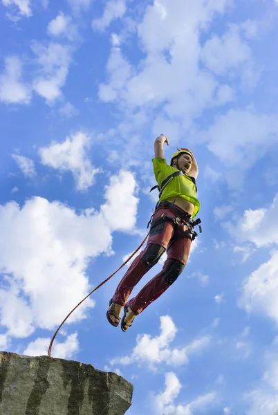 Jump rope from a high rock in the mountains.