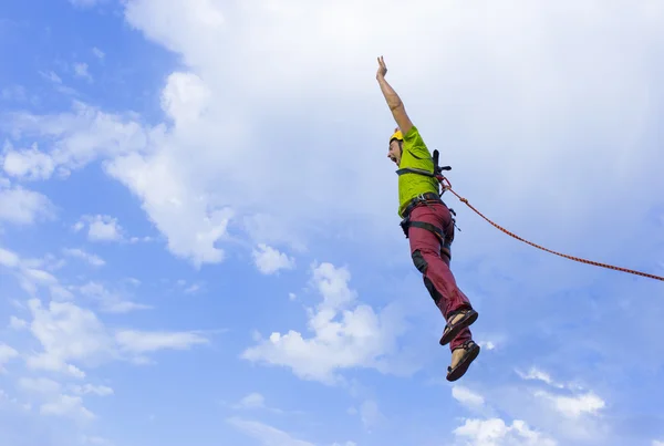 Jump rope from a high rock in the mountains.