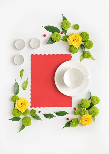 Paper, candles and cup for coffee or tea with wreath frame from