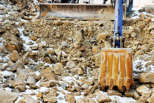 Small bulldozer excavator at construction site.