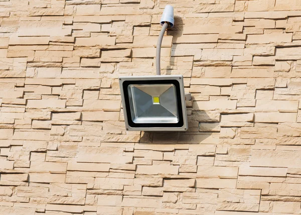 LED floodlight on wall of house.