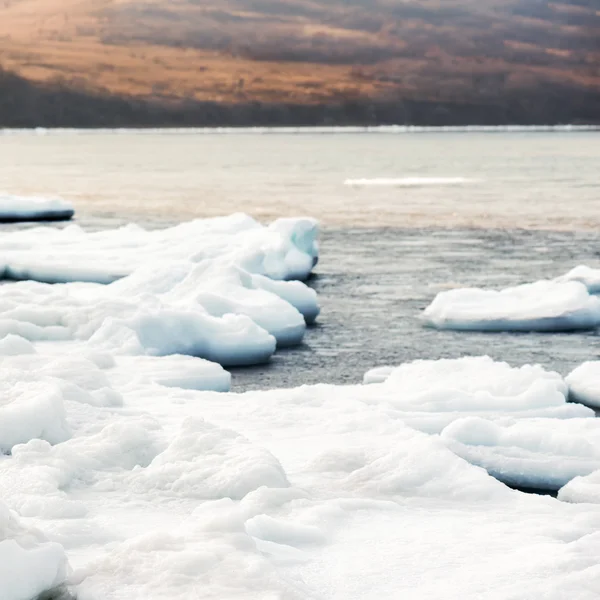 Natural sea ice blocks breaking up against shore.