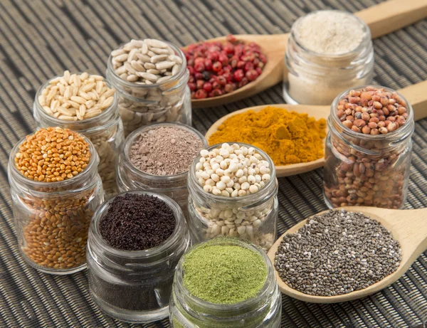 Variety of spices and grains on wooden background