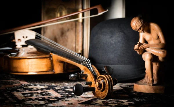 Detail violin - still life with a wooden figure, color version, due to the character contains grain / noise ratio and enhanced details