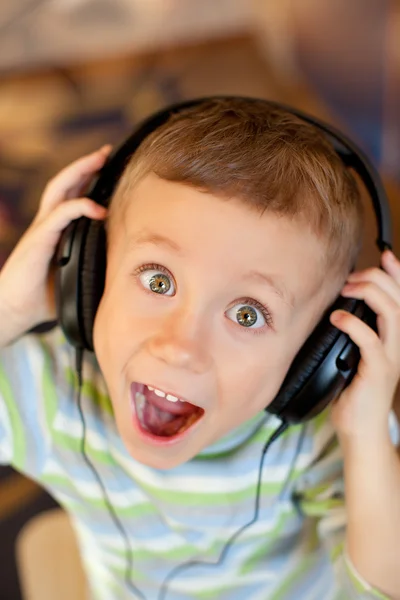 The child listens to music via earphones