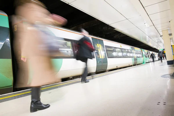 London Train Tube station Blur people movement in rush hour, at