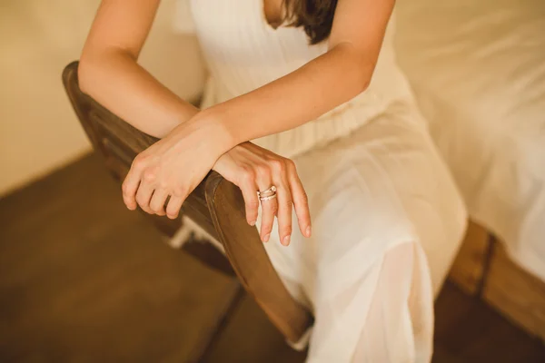 Hands of girl who sits on a chair