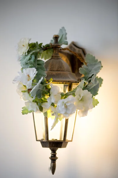 Golden lantern with wreath. Warm and cozy light