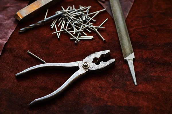 Pliers, nails, a file, an old rusty piece of metal