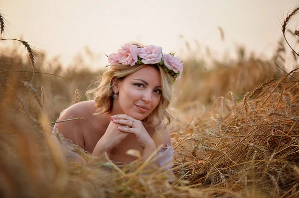 Beautiful girl with pink flowers wreath. Lovely hair and makeup .