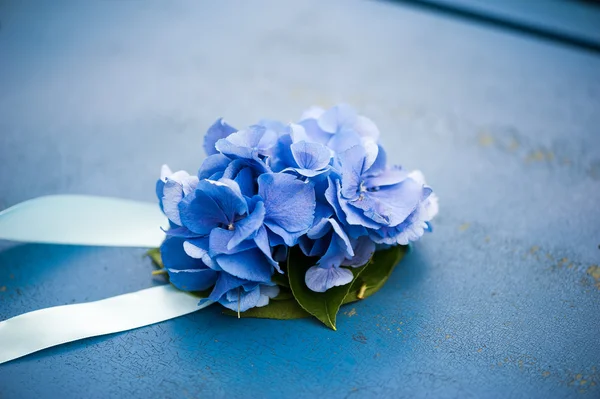 Decoration of hydrangeas on blue ribbons for metal texture