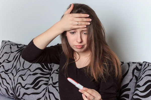 Young woman with a pregnancy test , the happiness of becoming a mother