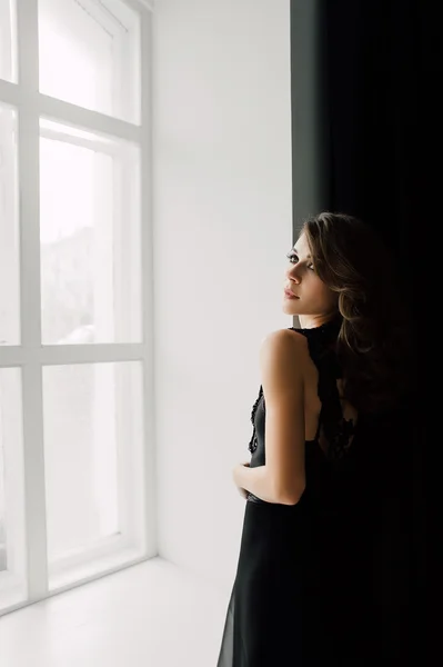 Individuality. Thoughtful Elegant Lady in Black Prom Evening Dress. Studio retouched photo.