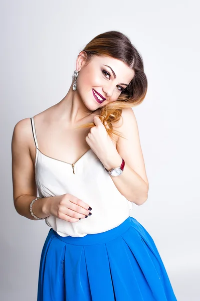 Bright positive fashion studio portrait of pretty young girl with purple lips, bright make up, sexy body, stylish trendy outfit: blue skirt, smart casual, cute emotions, color pop, white background.