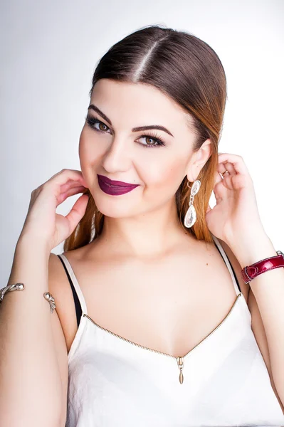 Bright positive fashion studio portrait of pretty young girl with purple lips, bright make up, sexy body, stylish trendy outfit: blue skirt, smart casual, cute emotions, color pop, white background.