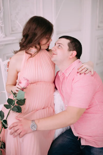 Family waiting for baby\'s birth. A pregnant woman and her husband wearing white clothing