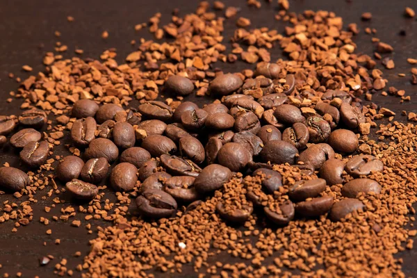 Coffee beans and ground coffee on brown table