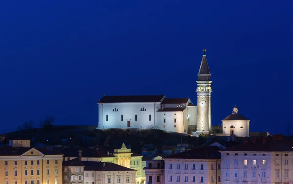 View of Old Church on the hill at night in the city of Piran, Slovenia