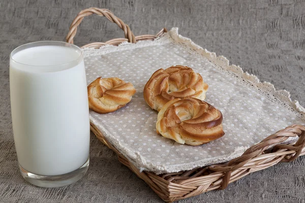 Milk and donuts on rustic wooden background