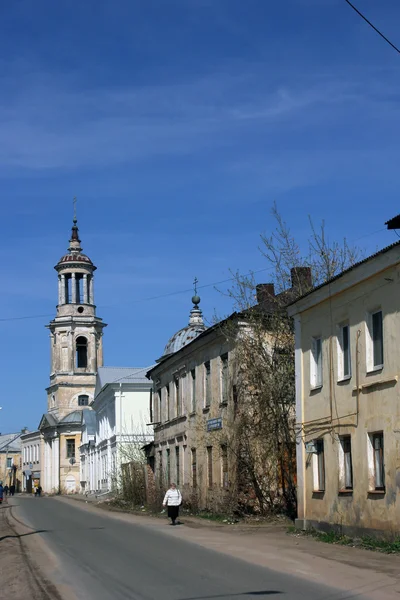 Provincial town street with old abandoned bell tower of orthodox