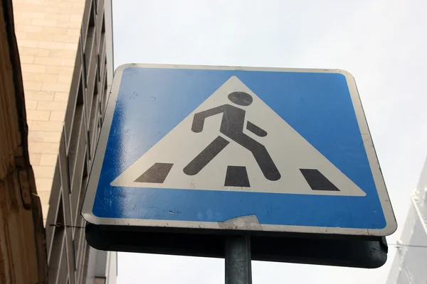 Blue street metal sign of pedestrian crossing closeup on street