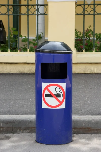 Blue metal city trash can with ashtray and no smoking sticker