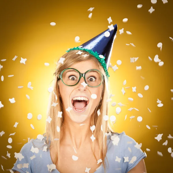 Young beautiful happy blonde girl at party with glasses portrait on yellow background