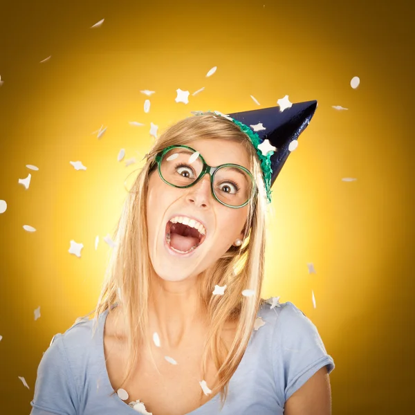 Young beautiful happy blonde girl at party with glasses portrait on yellow background