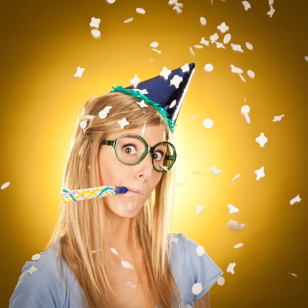 Young beautiful happy blonde girl at party with glasses portrait on yellow background