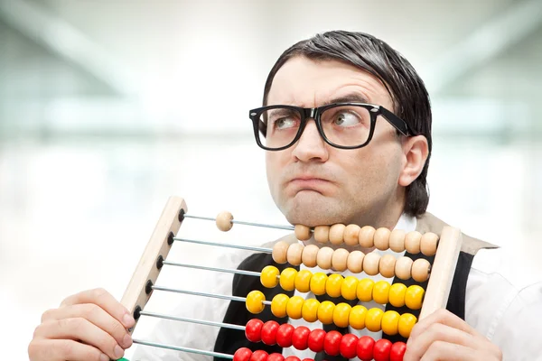 Funny nerd man with an abacus at office