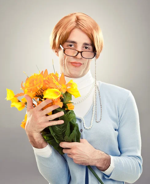 Ugly woman with glasses hold flowers on grey background