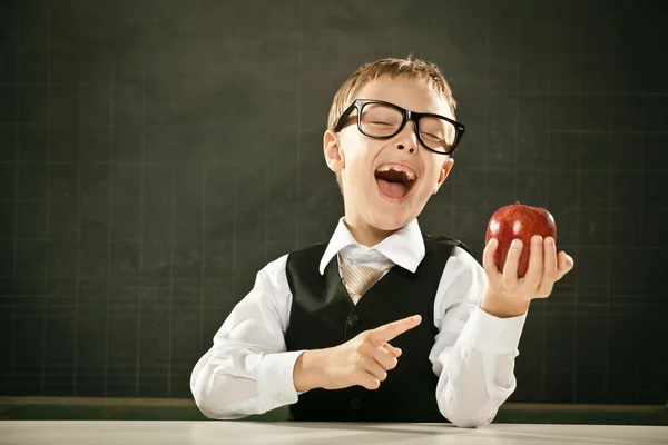 Young clever student think with apple and blackboard