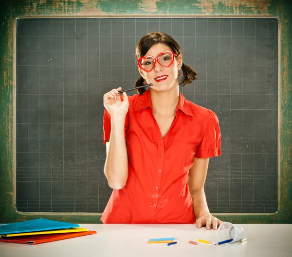 Sensual dreamy young student red dressed with glasses and blackboard