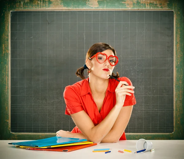 Sensual dreamy young student red dressed with glasses and blackboard